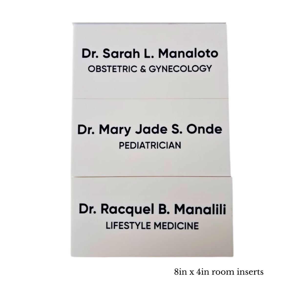 Three white rectangular doctor name cards stacked vertically on a white background, with black printed text showing physician names and specialties. Small text below reads '8in x 4in room inserts'.
